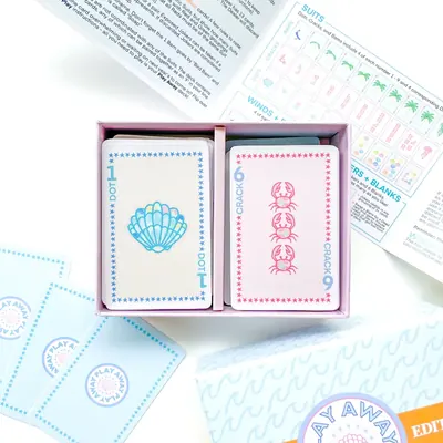 Beach Edition open tray showing a shell 1 Dot and a crab 6 Crack card with the guide unfolded behind