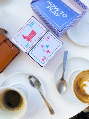 A Play Away box open on a coffee table with the how-to-play guide