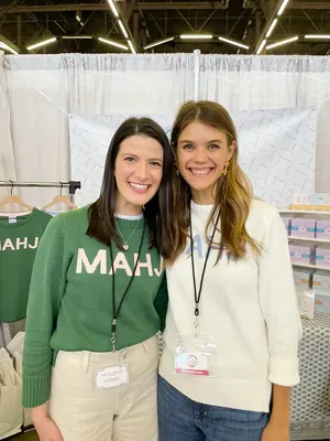 Two women wearing MAHJ Knit Sweaters in green and cream