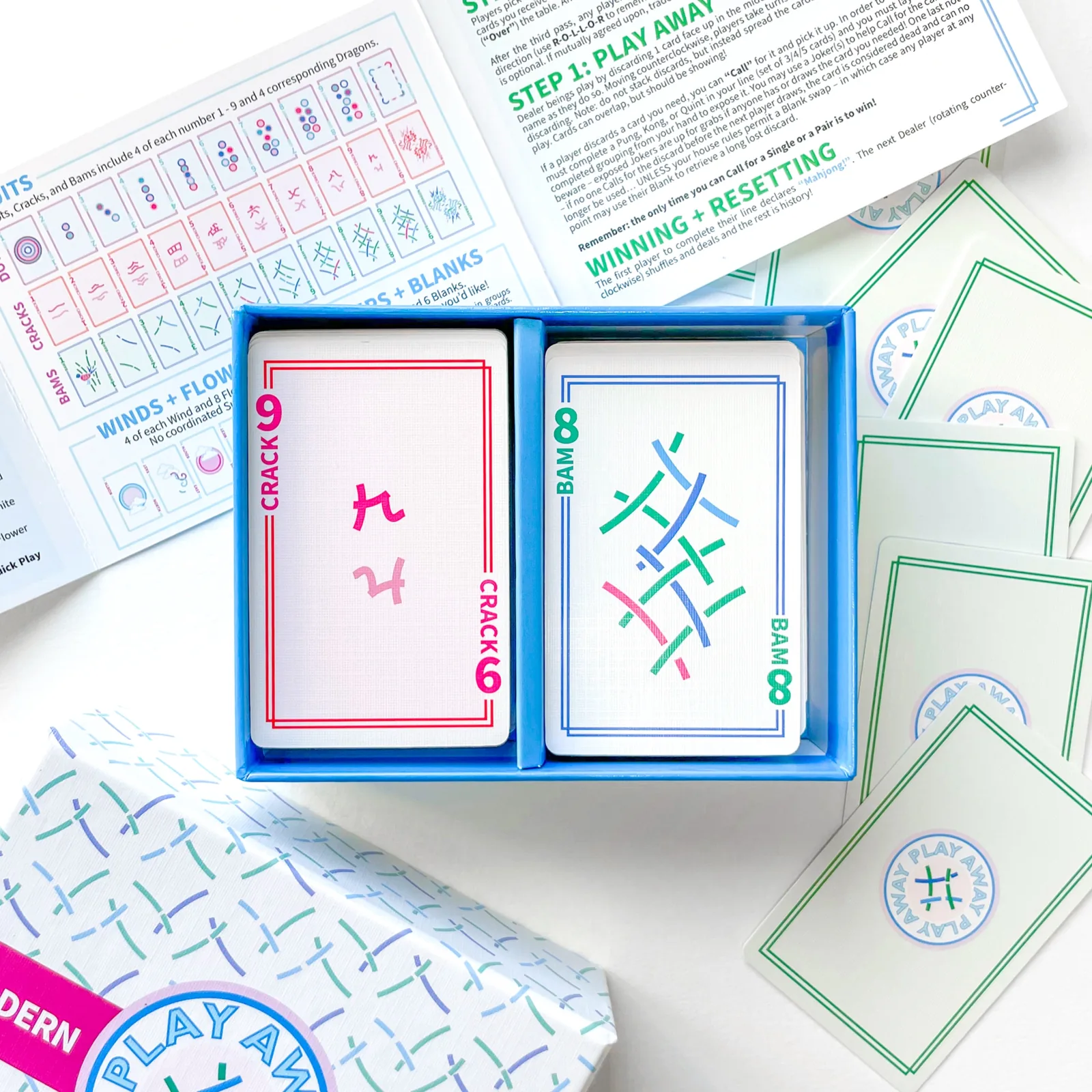 Modern Edition open tray: a 9 Crack and an 8 Bam card in fresh line art, guide unfolded behind