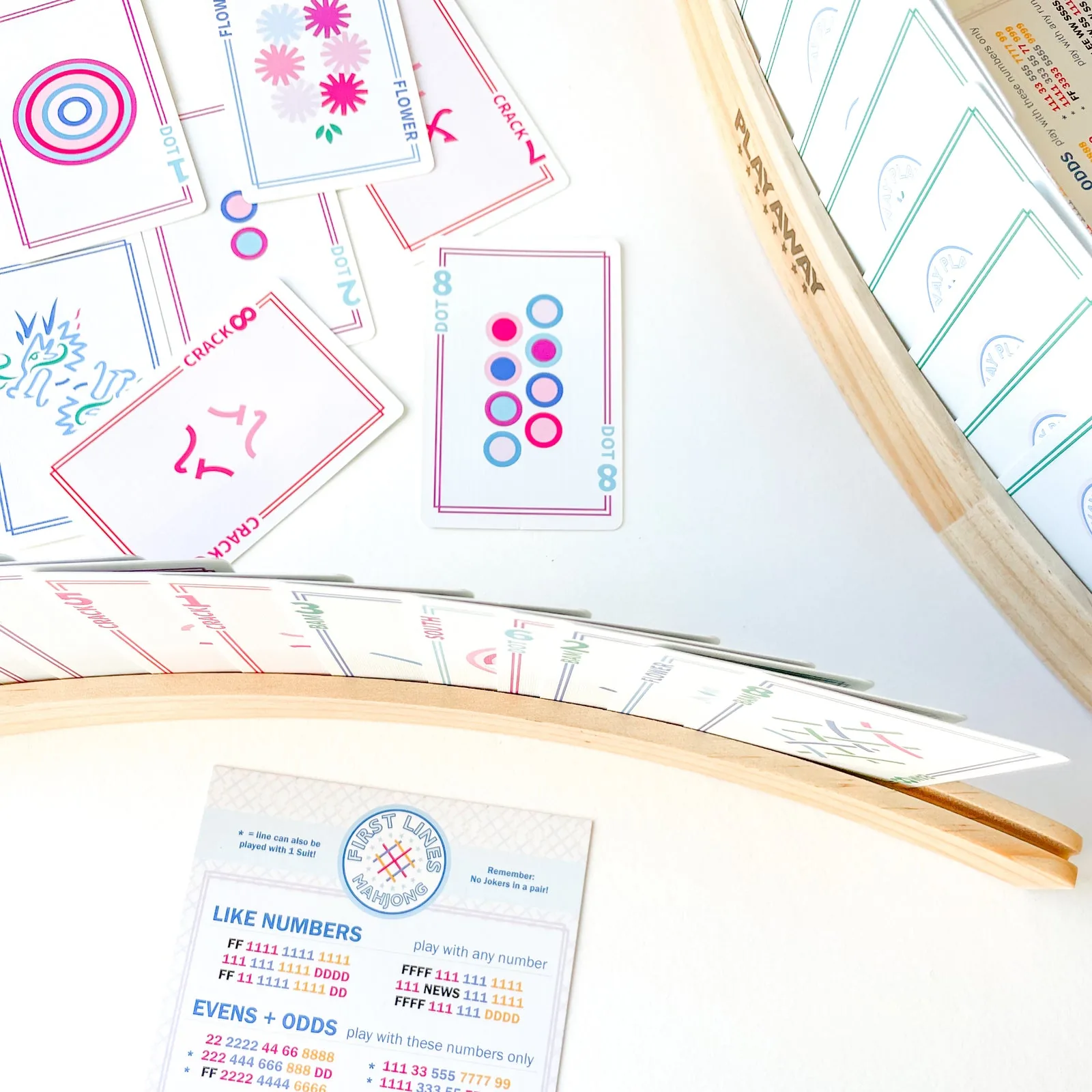Overhead of two wooden racks holding cards, loose Classic cards and a First Lines card on white
